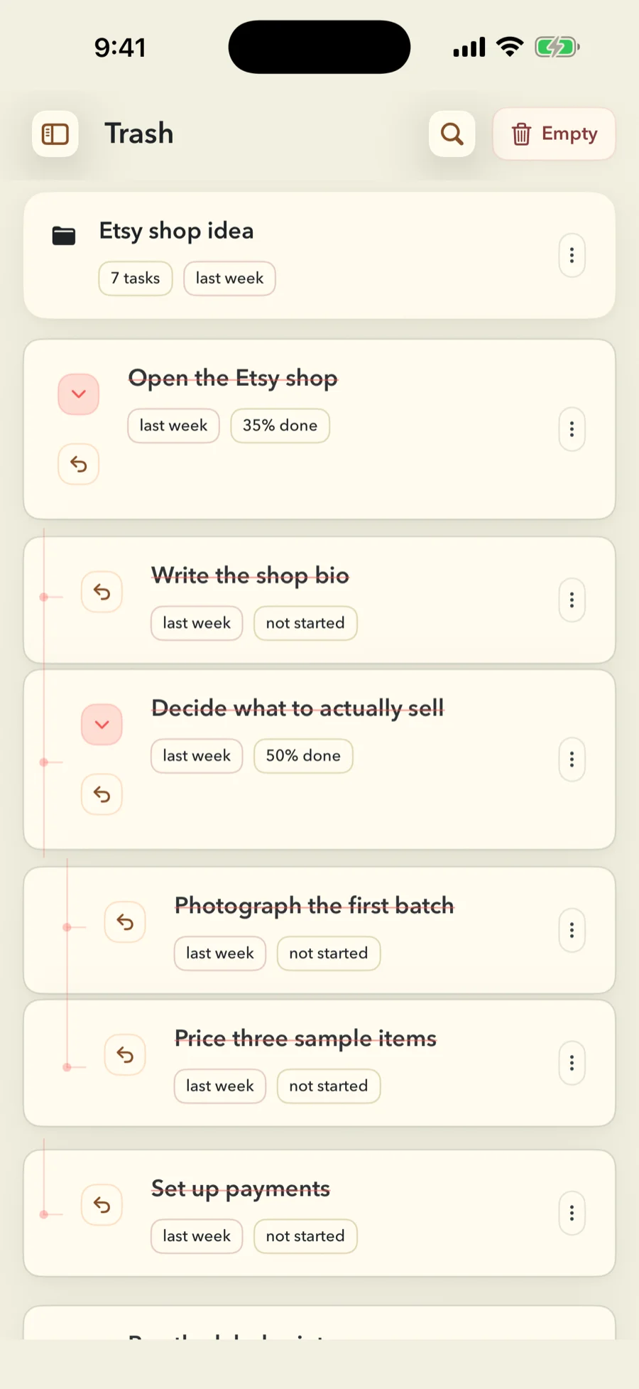 The FinishTrax Trash screen. A trashed folder called Etsy shop idea sits at the top, holding 7 tasks and removed last week. Beneath it the branch it came from is still nested: Open the Etsy shop at 35 percent, with Write the shop bio, Decide what to actually sell at 50 percent, Photograph the first batch, Price three sample items and Set up payments hanging off it on connecting lines. Every row carries a restore control and its own age, and an Empty button sits in the header.